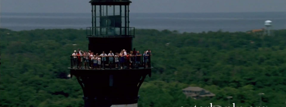 people standing on lighthouse balcony