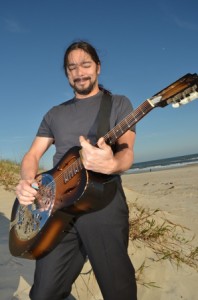 Lou Castro with a dobro. One of many instruments he plays.