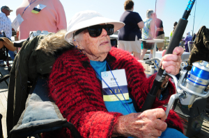 Elsa Jennings from Henderson County, fishes grin Avalon Fishing Pier. The 100-year-old woman ldest participant in the VIP Fishing Tournament. Photo: Michael H. Schwartz/Thin Blue Line Productions