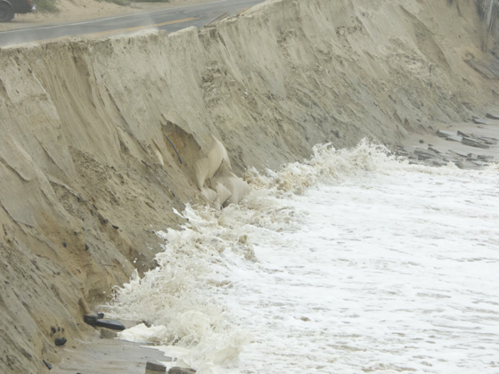 Sandbags exposed by wave action at repaired section of the Beach Road. Photo, Kip Tabb