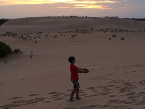 Flying a kite at sunset at Jockey's Ridge State Park.