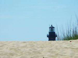 Currituck Beach Lighthouse peering over the edge of a Corolla sand dune.