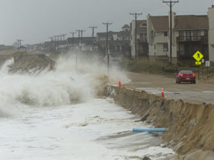 Waves breaking over Beach Road by Kitty Hawk Bathhouse. The waves undercut the road, and it's now closed waiting for repairs. Photo Kip Tabb