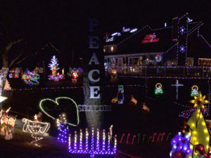 Poulos house with lights showing universal message of the family. Photo Kip Tabb