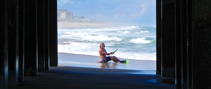 Calm before the storm: A body boarder on a deserted beach at Jennette’s Pier. (Rob Morris)