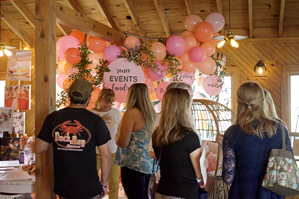 Couples gather for more information about the Outer Banks as a wedding destination at the Kitty Hawk Pier during the OBX Wedding Fest.